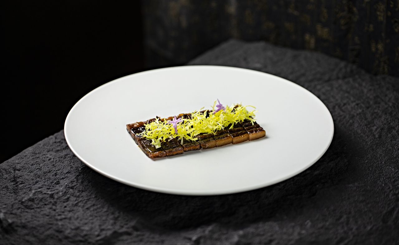 About Elegant gourmet dish garnished with edible flowers on a white plate. Perfect for fine dining concepts.