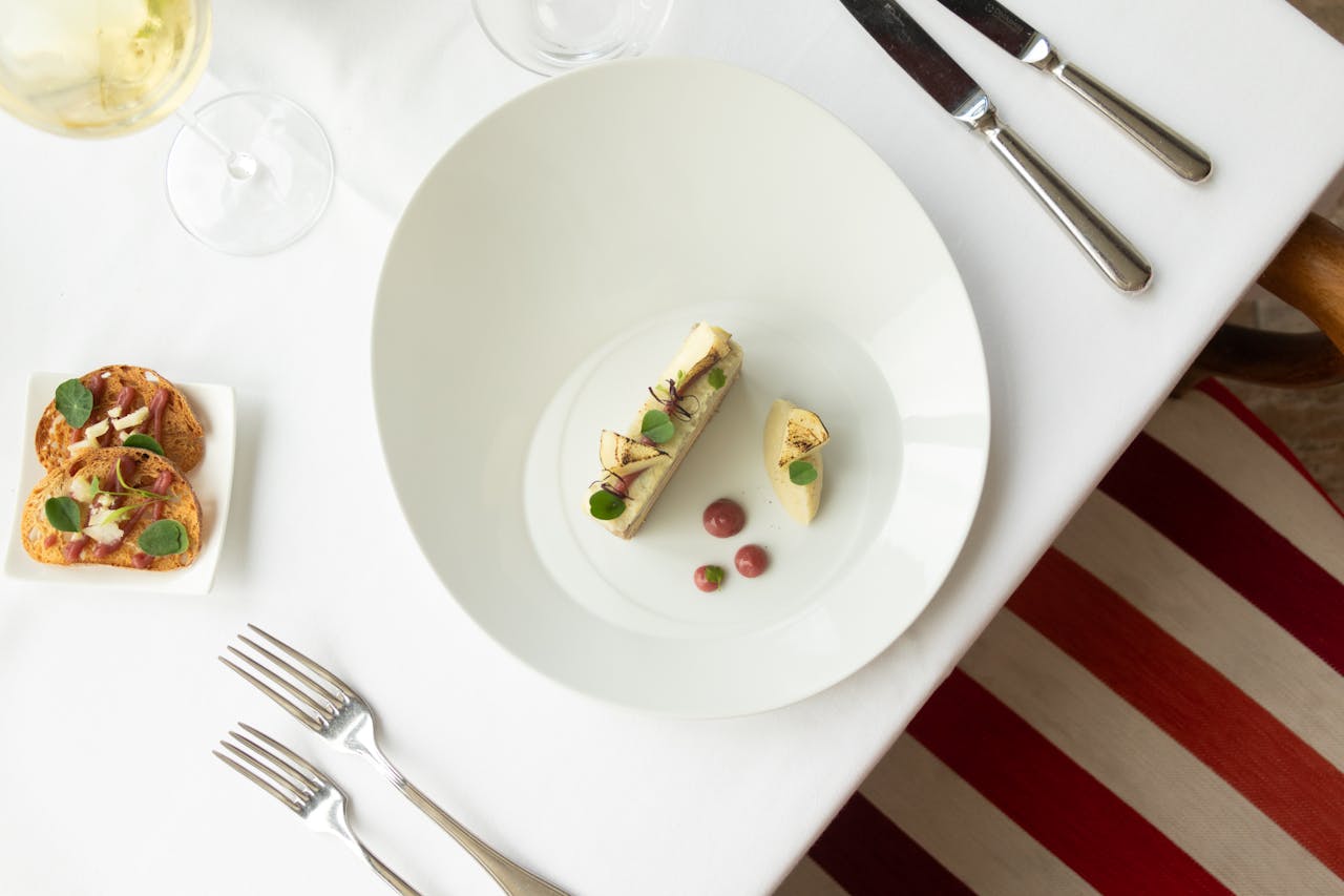 Top view of gourmet French cuisine in a fine dining setup, Vonnas, France.