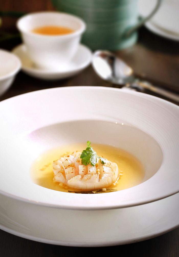 Close-up of a gourmet seafood dish elegantly presented in a restaurant setting.
